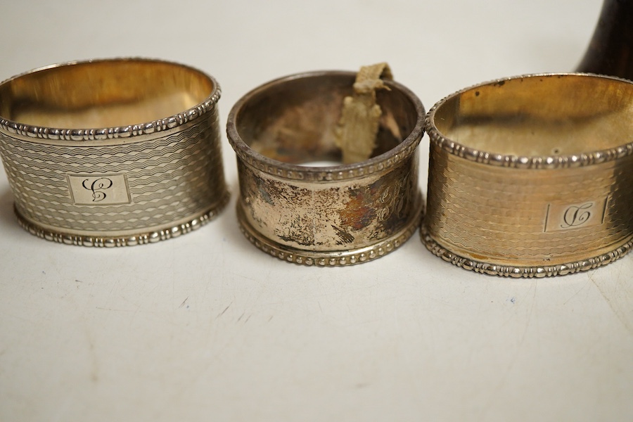 Assorted silver napkin rings, to include a George V engine turned oval pair, Birmingham, 1933, I S Greenberg & Co, initialled, four others and a pepper pot, weight approx. 6.34ozt
